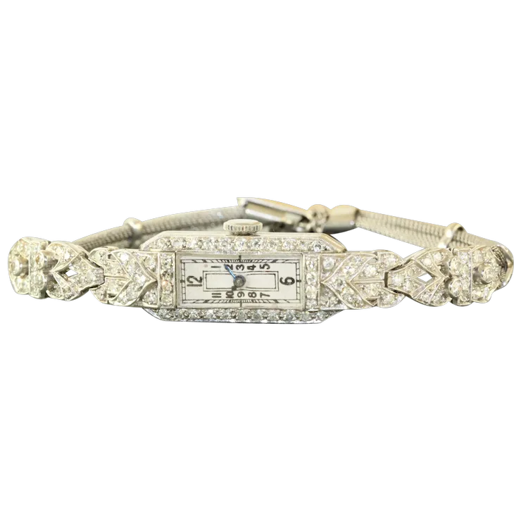 Vintage-style wristwatch with decorative band on a white background