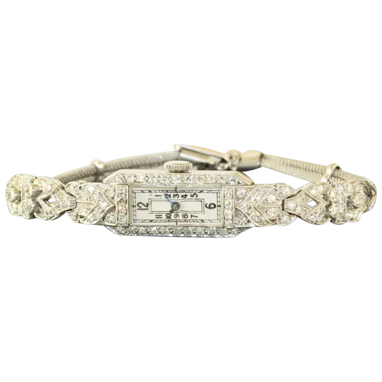 Vintage-style wristwatch with decorative band on a white background