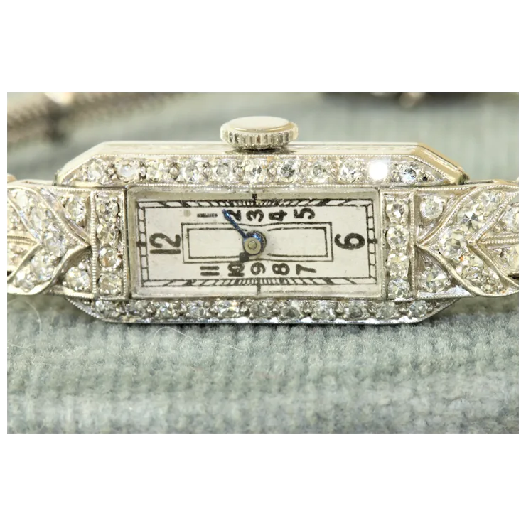 Decorative watch face with diamond accents on a white background