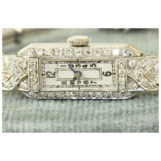 Decorative watch face with diamond accents on a white background