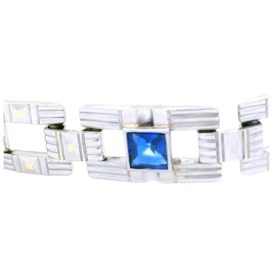 Silver bracelet with a blue gemstone on a white background
