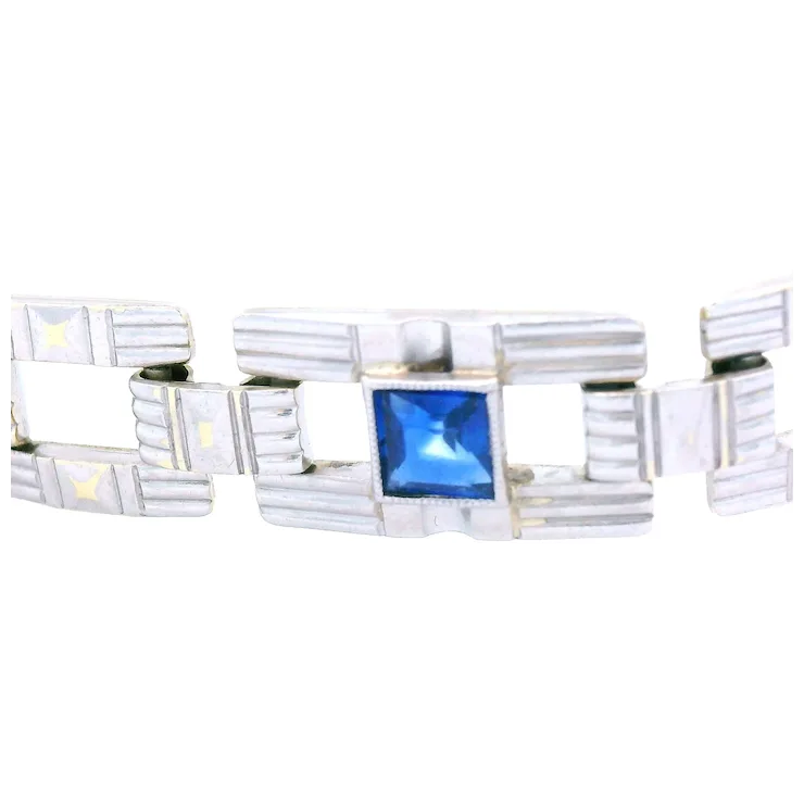 Silver bracelet with a blue gemstone on a white background