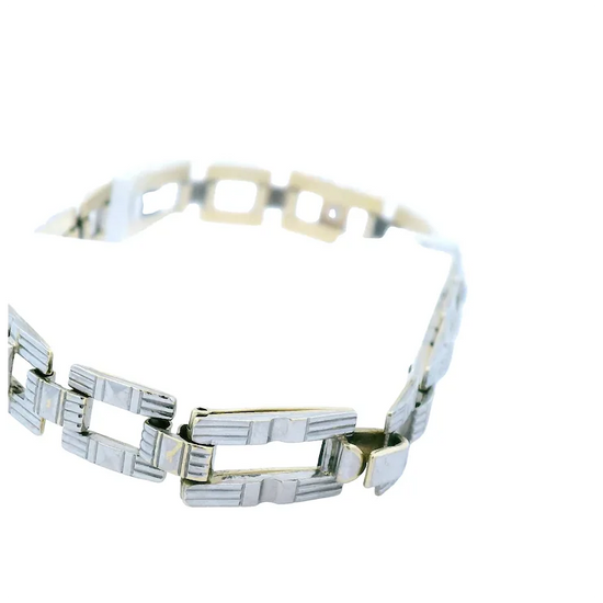 Silver and gold bracelet on a white background