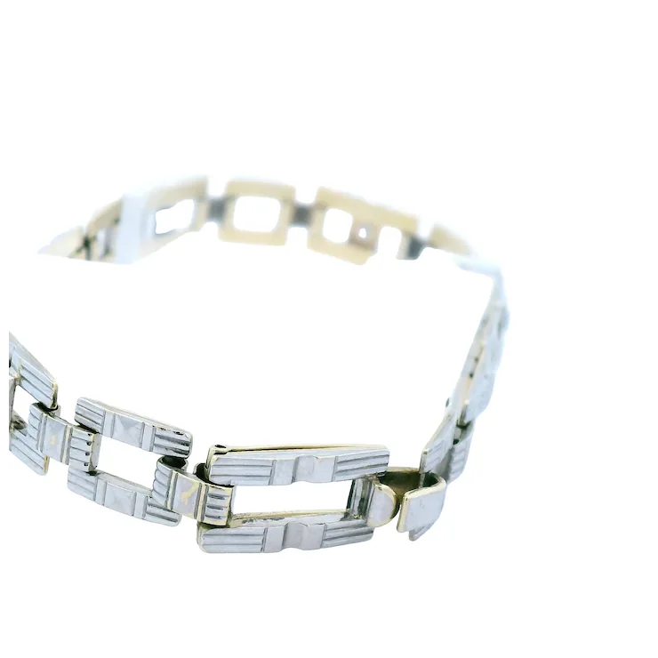 Silver and gold bracelet on a white background