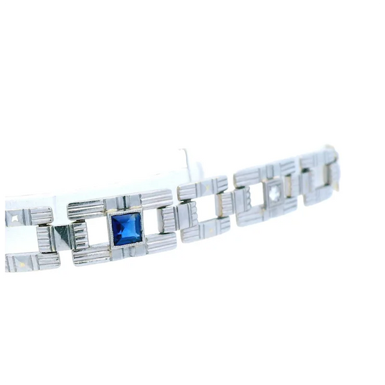 Silver bracelet with a blue gemstone on a white background