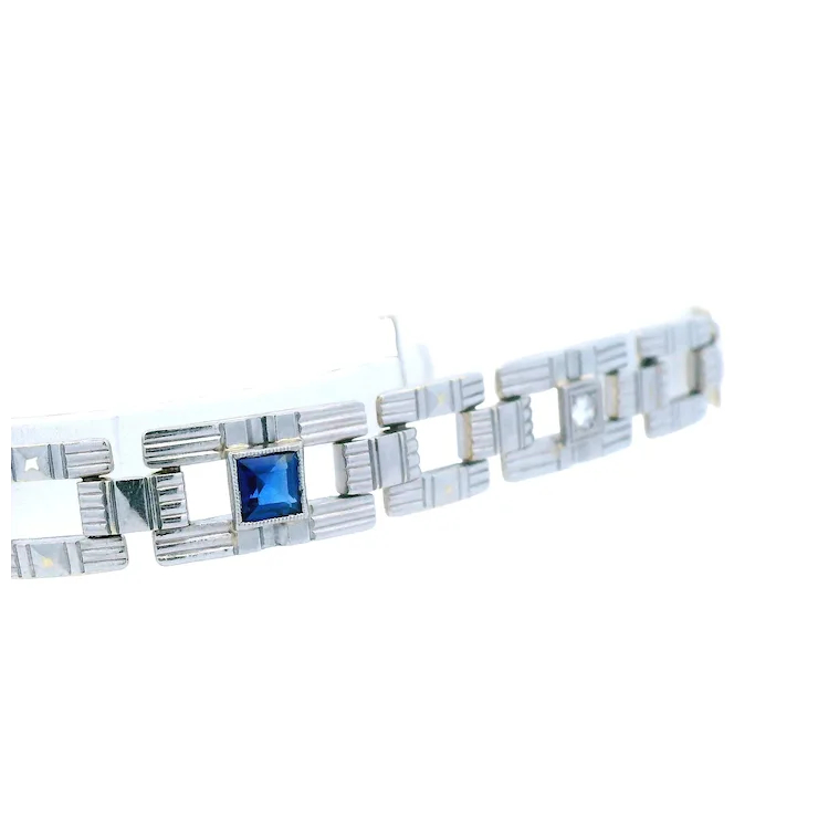 Silver bracelet with a blue gemstone on a white background