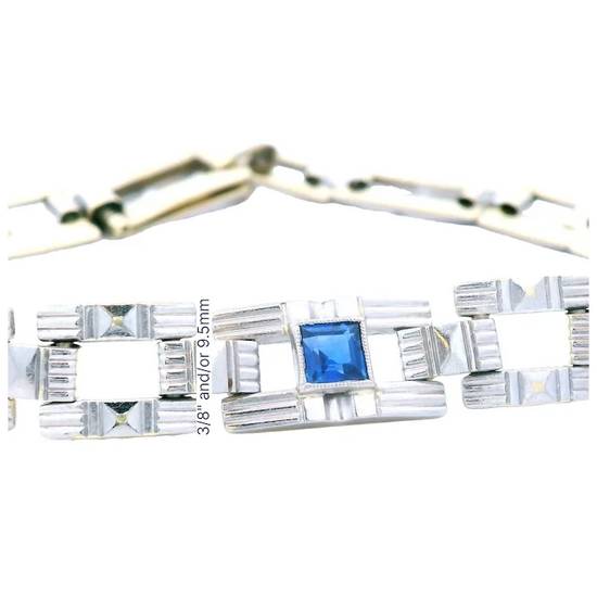 Silver bracelet with a blue gemstone on a white background