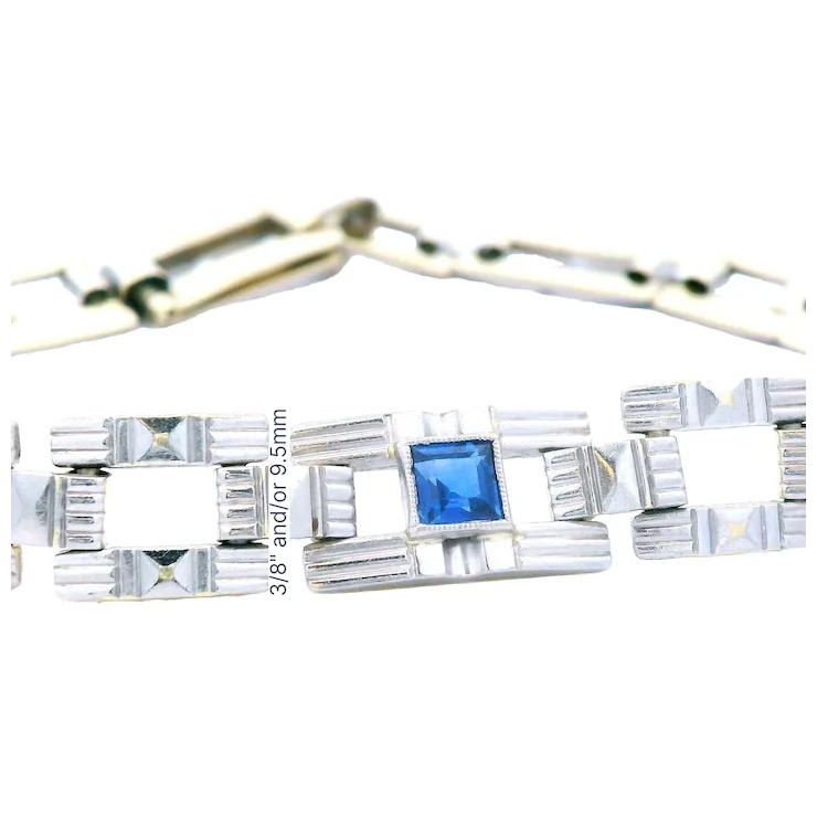 Silver bracelet with a blue gemstone on a white background