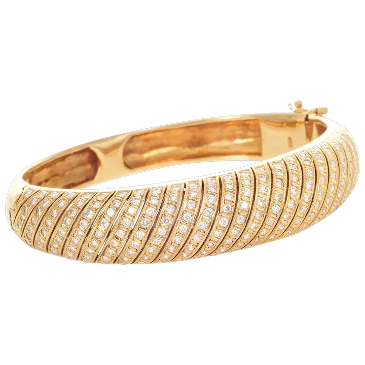 Gold bracelet with diamond accents on a white background