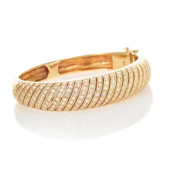 Gold bracelet with diamond accents on a white background