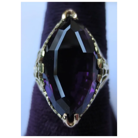 Ring with a large purple gemstone on a dark background