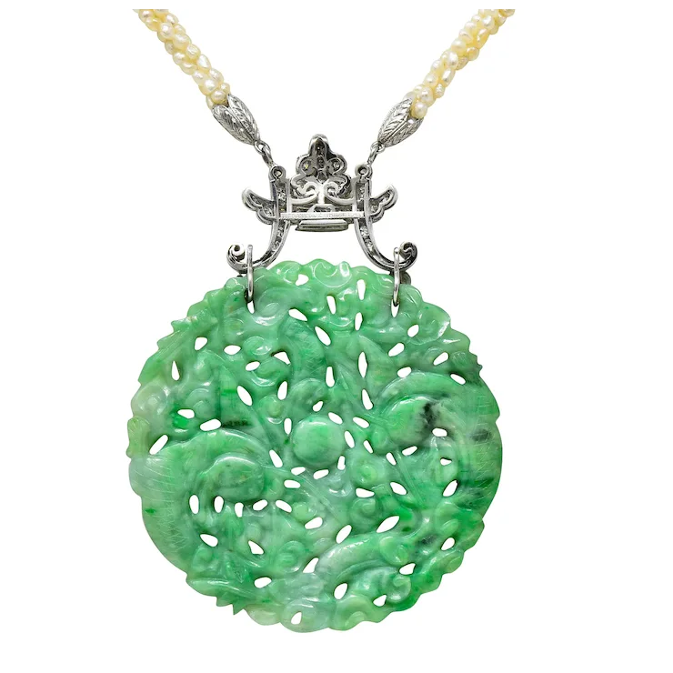 Green jade pendant with silver chain on a white background