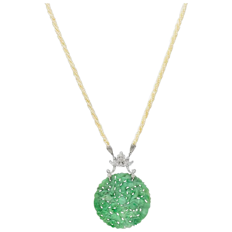Green pendant necklace with a yellow chain on a white background