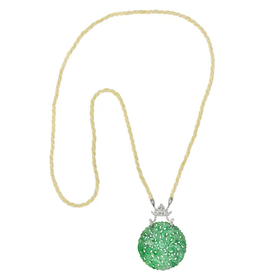 Green pendant necklace with gold chain on a white background