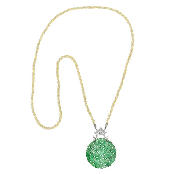 Green pendant necklace with gold chain on a white background