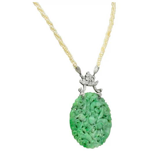 Green jade pendant necklace with gold chain on a white background