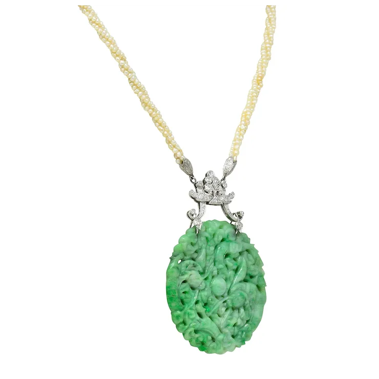 Green jade pendant necklace with gold chain on a white background