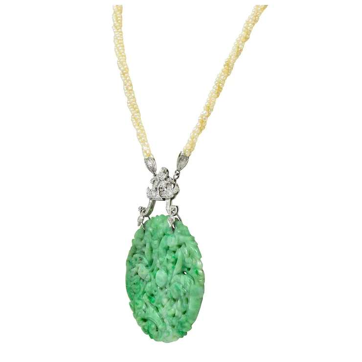 Necklace with a green pendant and yellow beads on a white background