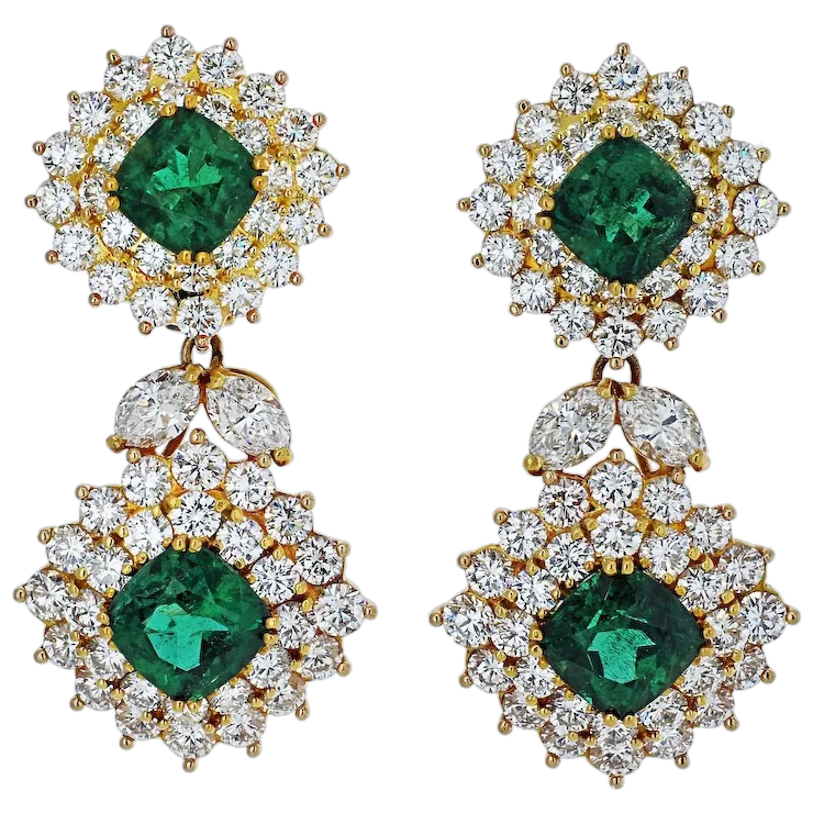 Pair of earrings with green gemstones and gold accents on a white background