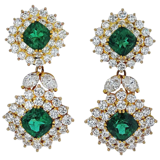 Pair of earrings with green gemstones and gold accents on a white background