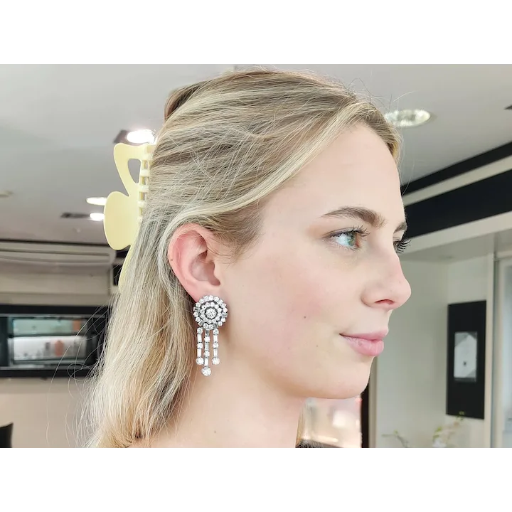 Woman wearing a decorative earring in an indoor setting