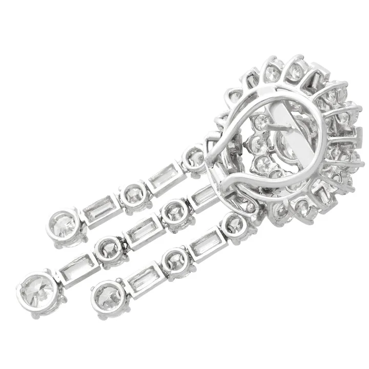 Close-up of a silver bracelet with diamond accents on a white background