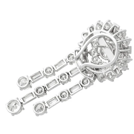 Close-up of a silver bracelet with diamond accents on a white background