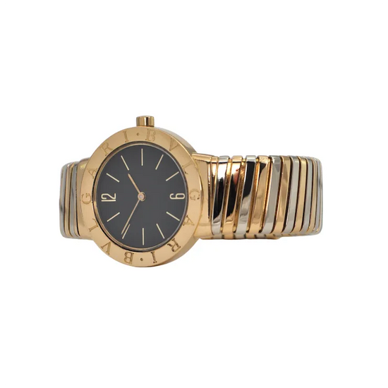 Gold and silver watch with black face on a white background