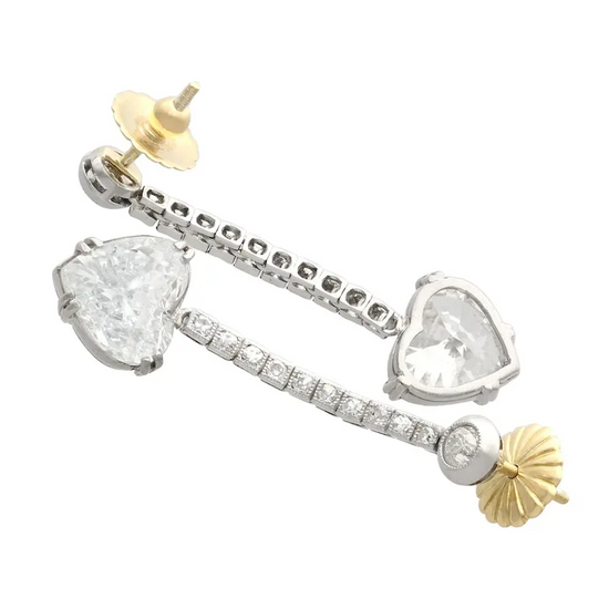 Pair of earrings with heart and pear-shaped gemstones on a white background