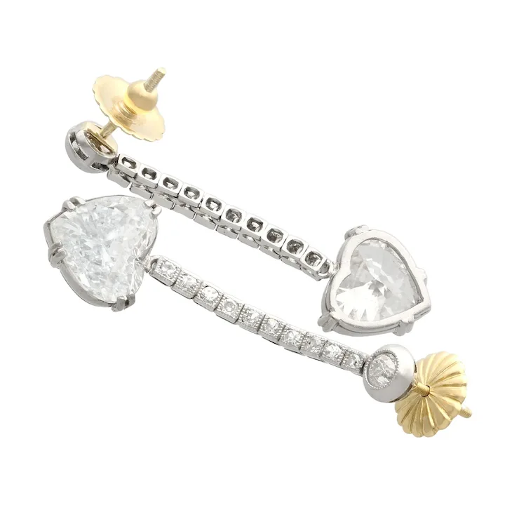 Pair of earrings with heart and pear-shaped gemstones on a white background