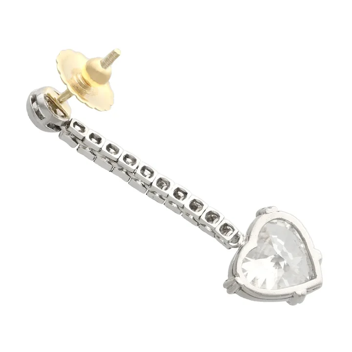 Heart-shaped crystal earring with gold and silver components on a white background