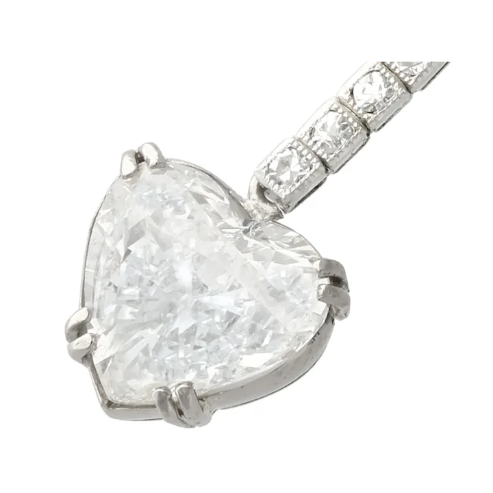 Pear-shaped diamond pendant with a white gold setting on a white background
