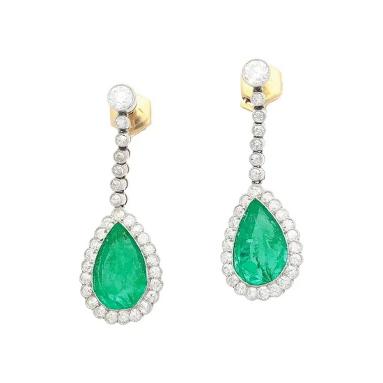 Pair of emerald and diamond earrings on a white background
