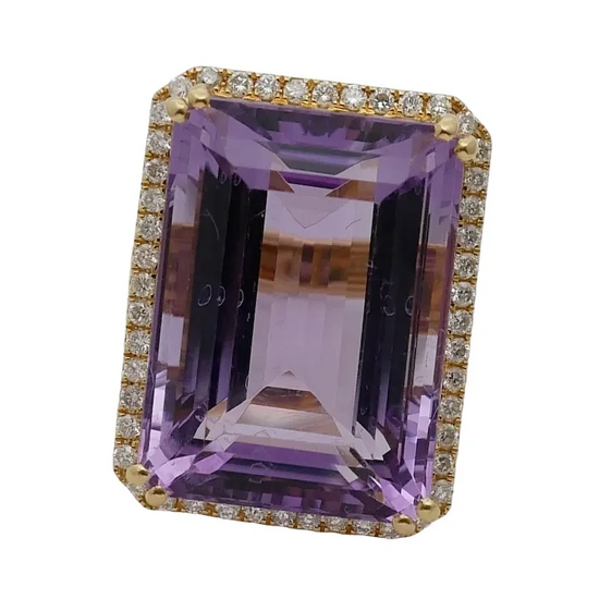 Purple gemstone ring with gold and diamond accents on a white background