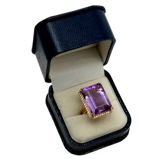 Amethyst ring in a black box on a white background