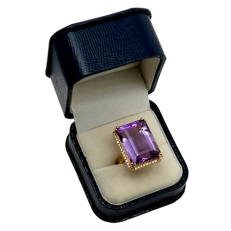 Amethyst ring in a black box on a white background