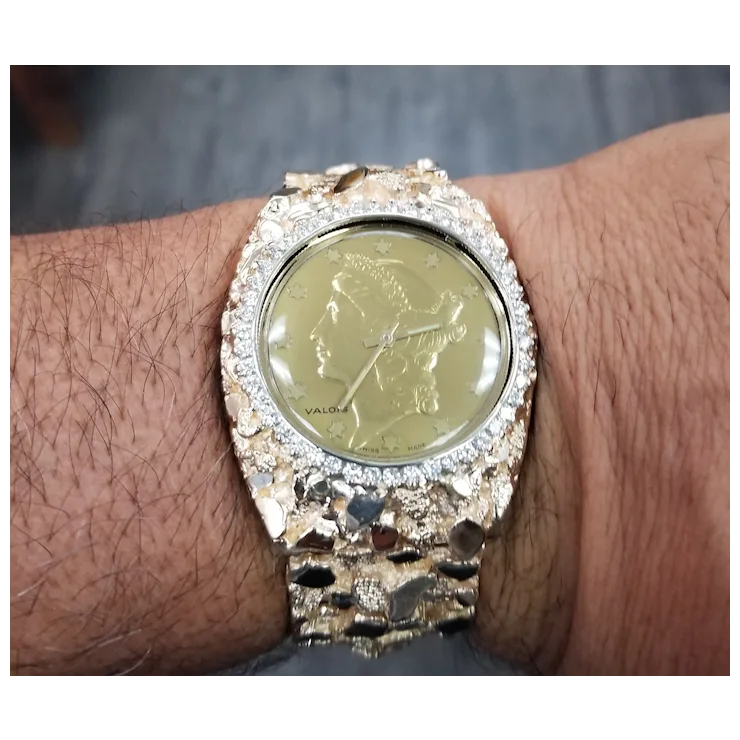 Gold watch with diamond-studded bezel on a wrist