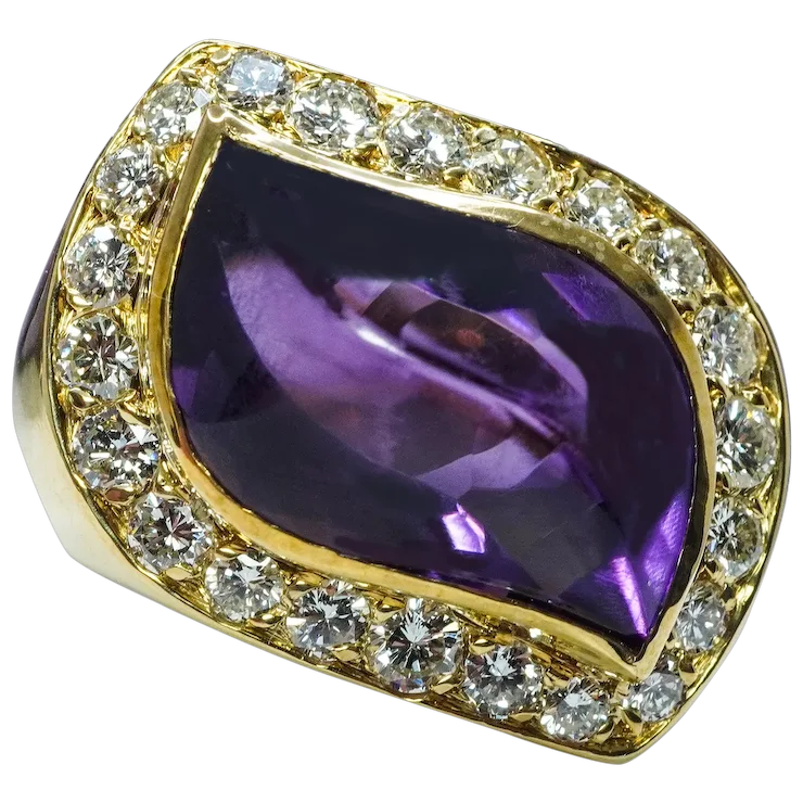 Gold ring with a purple gemstone and diamond accents on a white background