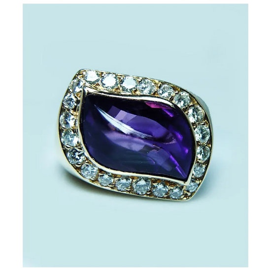 Jewelry with a purple gemstone and diamond-studded border on a light blue background