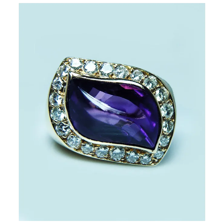 Jewelry with a purple gemstone and diamond-studded border on a light blue background