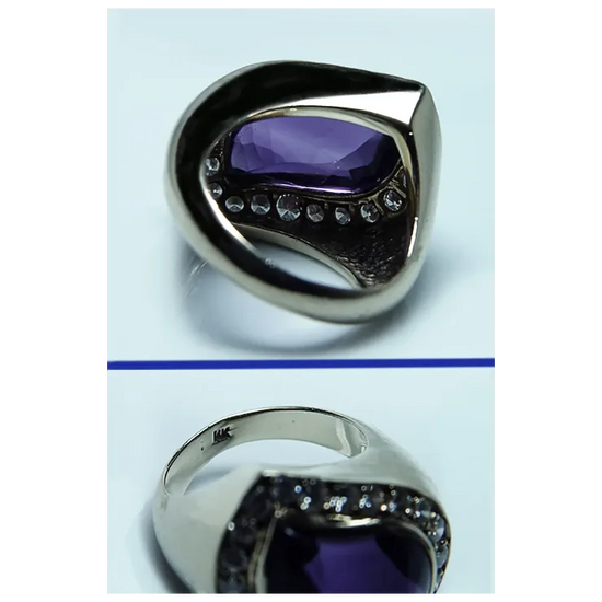 Silver ring with a purple gemstone on a light blue background