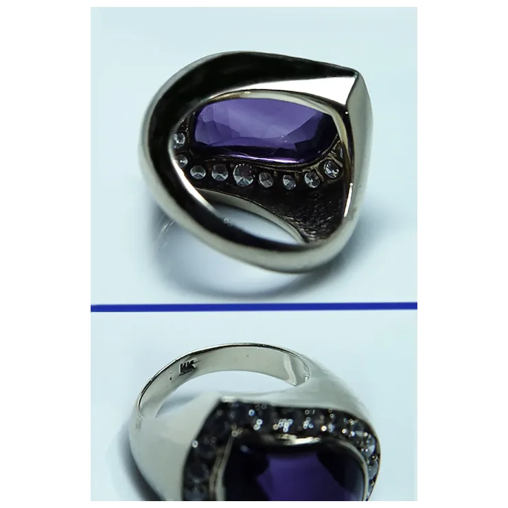 Silver ring with a purple gemstone on a light blue background