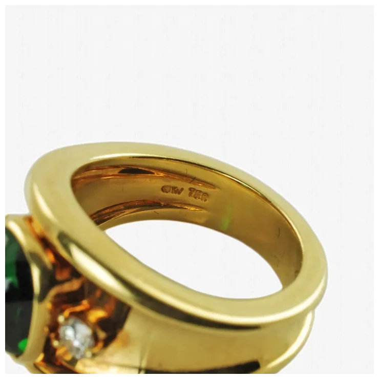 Gold ring with gemstones on a white background