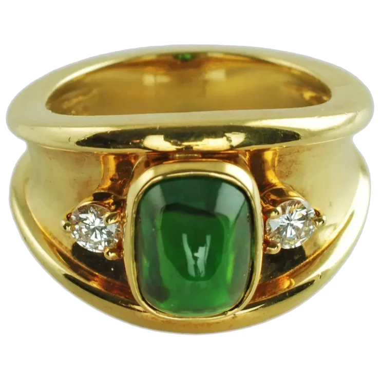 Gold ring with a green gemstone and two diamonds on a white background