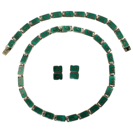 Green and silver jewelry set including a necklace and earrings on a white background