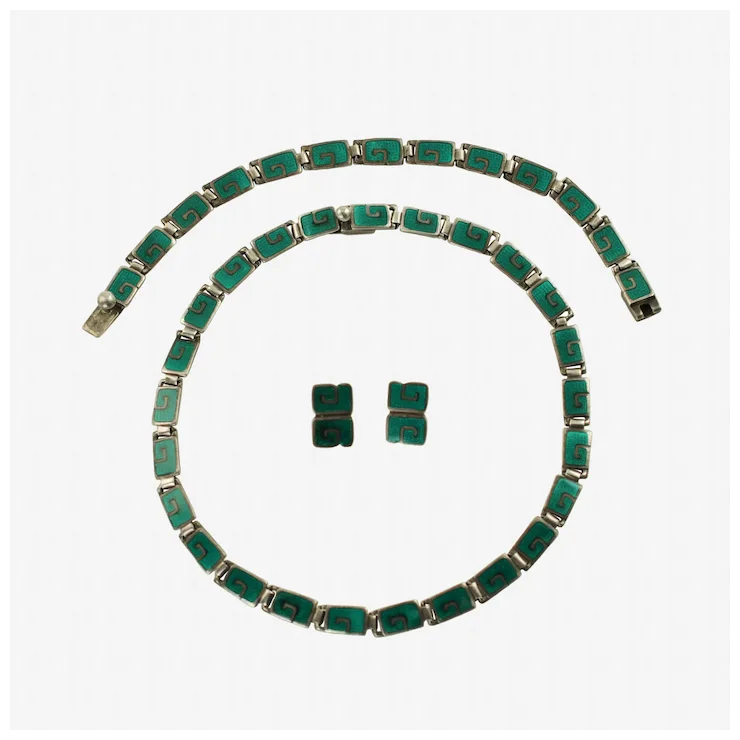 Green emerald jewelry set including necklace and earrings on a white background