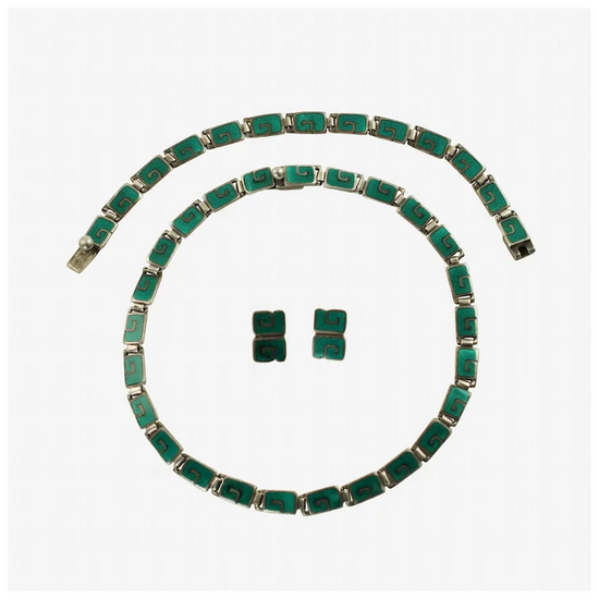 Green emerald jewelry set including necklace and earrings on a white background