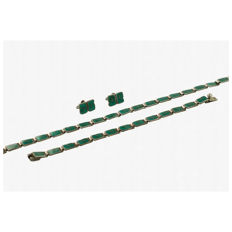 Green jewelry set with bracelet and earrings on a white background