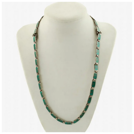 Turquoise necklace on a white mannequin bust