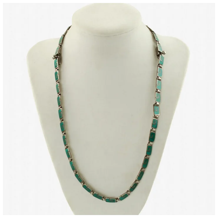 Turquoise necklace on a white mannequin bust